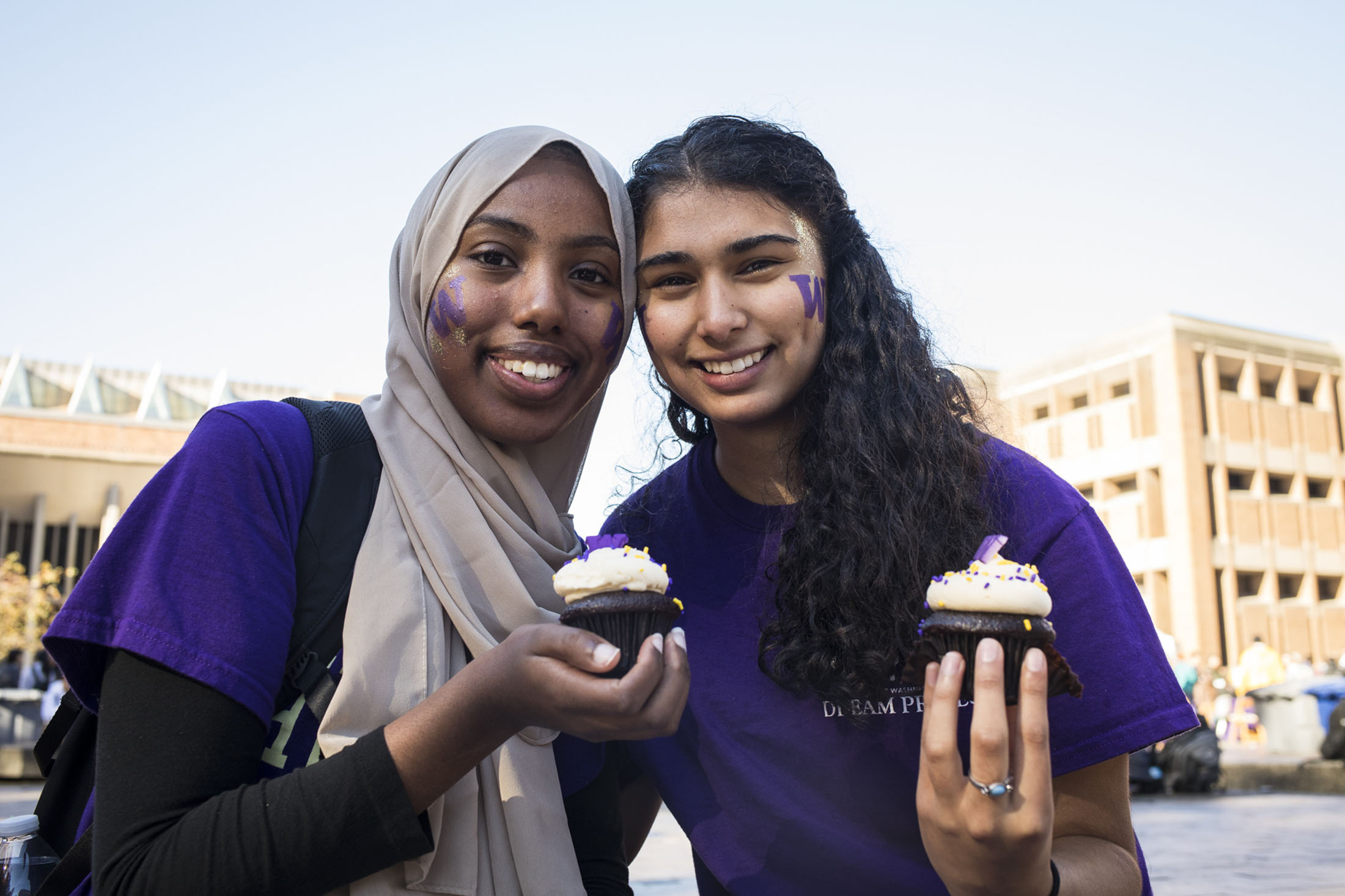 Two UW Students holding cupcakes in Red Square